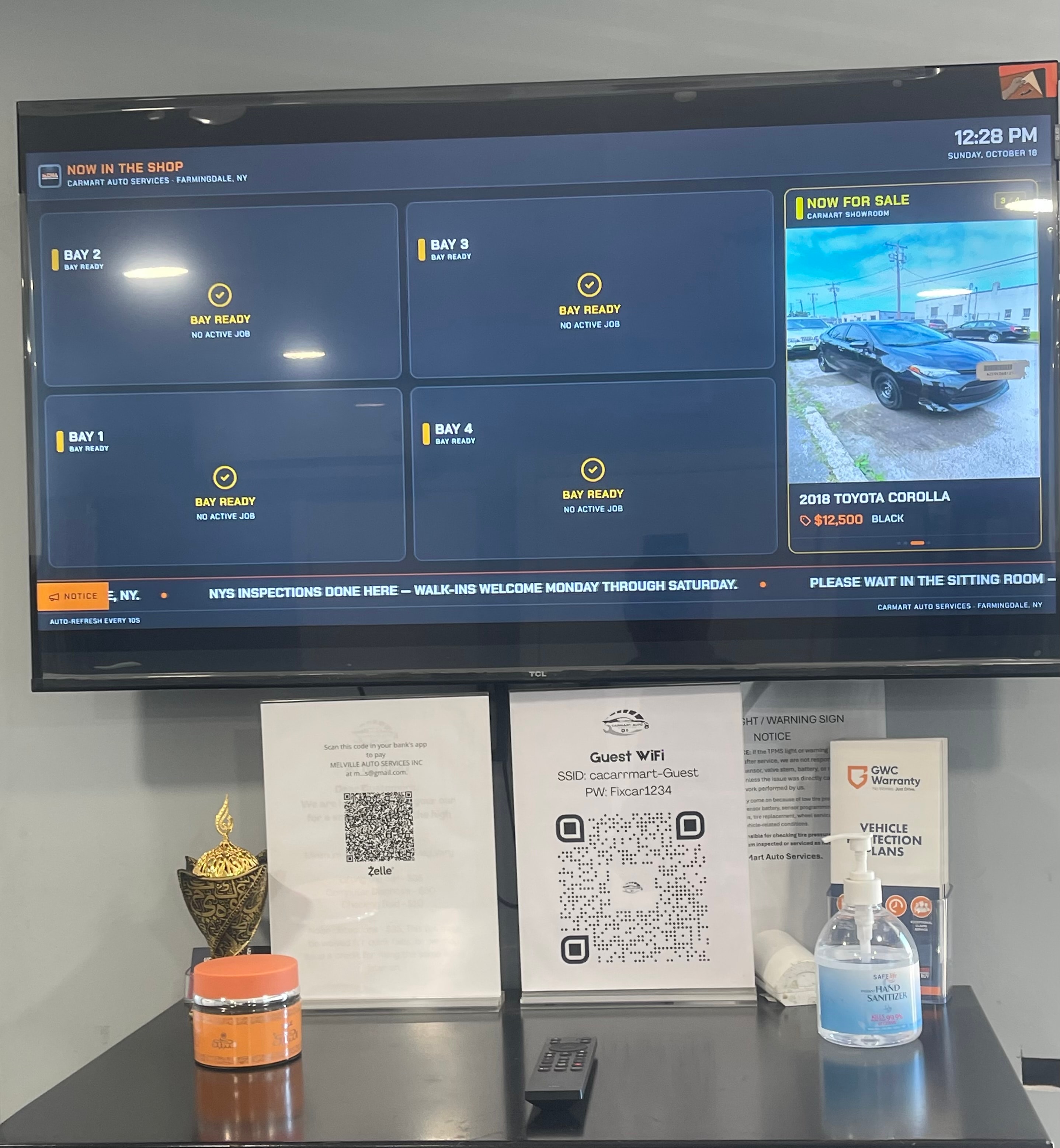 CarMart office with bay status display screen